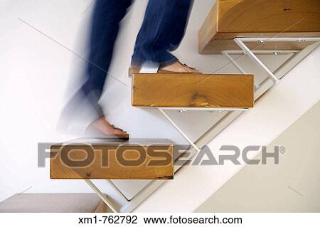 Young woman climbing stairs View Large Photo Image Stock Image - Young woman climbing stairs. Fotosearch