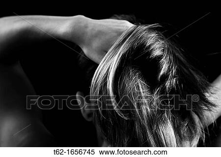 Stock Photography - Young woman combing, back Blonde hair. Fotosearch