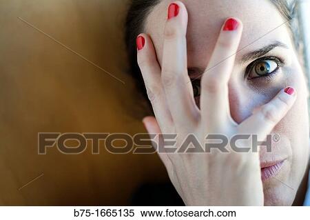Stock Photography - Young woman covering her face with her hands. Fotosearch