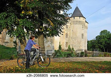 young woman cycling in front of the Castle St-Jean, Nogent-le-Rotrou, Parc naturel regional du Perche, Eure & Loir department, region Centre, France, Europe. View Large Photo Image Stock Photography - young woman cycling in front of the Castle St-Jean, Nogent-le-Rotrou, Parc naturel regional du Perche, Eure & Loir department, region Centre, France, Europe.. Fotosearch