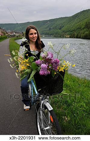 young woman cycling on cycle lane along the Meuse River at Haybes, Ardennes department, Champagne-Ardenne region of northeasthern France, Europe. View Large Photo Image Stock Image - young woman cycling on cycle lane along the Meuse River at Haybes, Ardennes department, Champagne-Ardenne region of northeasthern France, Europe.. Fotosearch