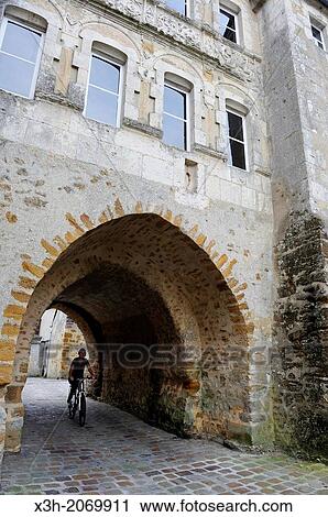young woman cycling under the Saint-Denis Gate, Mortagne-au-Perche, Regional Natural Park of Perche, Orne department, Lower Normandy region, France, Western Europe. View Large Photo Image Stock Image - young woman cycling under the Saint-Denis Gate, Mortagne-au-Perche, Regional Natural Park of Perche, Orne department, Lower Normandy region, France, Western Europe.. Fotosearch
