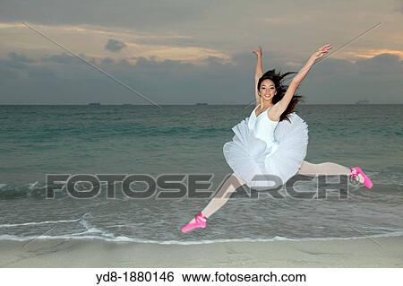 Young woman dancer jumping on the beach, Miami Beach, Florida, USA View Large Photo Image Stock Photograph - Young woman dancer jumping on the beach, Miami Beach, Florida, USA. Fotosearch