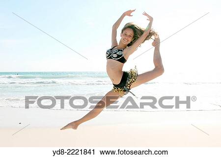 Young woman doing ballet jumping on the beach in Miami Beach, Florida, USA View Large Photo Image Stock Image - Young woman doing ballet jumping on the beach in Miami Beach, Florida, USA. Fotosearch