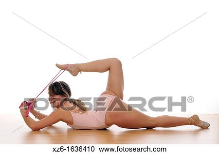 Stock Image - young woman doing exercise, gymnastics, with a rope. Fotosearch