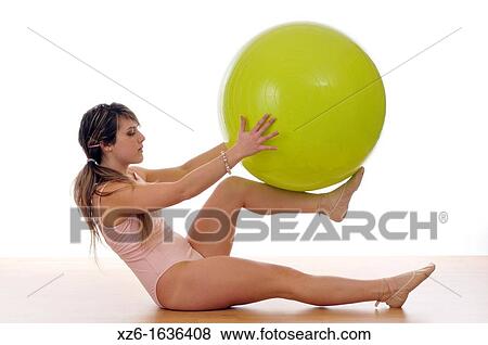 young woman doing exercise, gymnastics, with a large green ball, giant ball View Large Photo Image Stock Photo - young woman doing exercise, gymnastics, with a large green ball, giant ball. Fotosearch