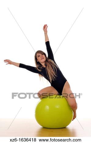 young woman doing exercise, gymnastics, with a large green ball, giant ball View Large Photo Image Stock Photo - young woman doing exercise, gymnastics, with a large green ball, giant ball. Fotosearch