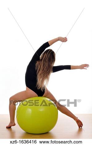 young woman doing exercise, gymnastics, with a large green ball, giant ball View Large Photo Image Stock Photograph - young woman doing exercise, gymnastics, with a large green ball, giant ball. Fotosearch
