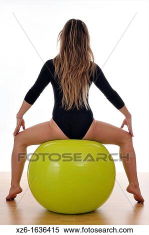 young woman doing exercise, gymnastics, with a large green ball, giant ball View Large Photo Image Stock Photography - young woman doing exercise, gymnastics, with a large green ball, giant ball. Fotosearch
