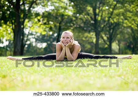 Young woman doing gymnastics in park View Large Photo Image Stock Image - Young woman doing gymnastics in park. Fotosearch