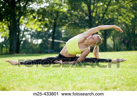Young woman doing gymnastics in park View Large Photo Image Stock Image - Young woman doing gymnastics in park. Fotosearch
