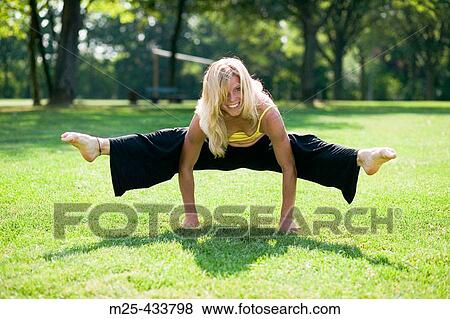 Young woman doing gymnastics in park View Large Photo Image Stock Photo - Young woman doing gymnastics in park. Fotosearch