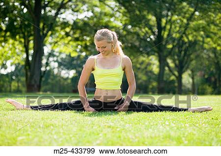 Young woman doing gymnastics in park View Large Photo Image Stock Photo - Young woman doing gymnastics in park. Fotosearch