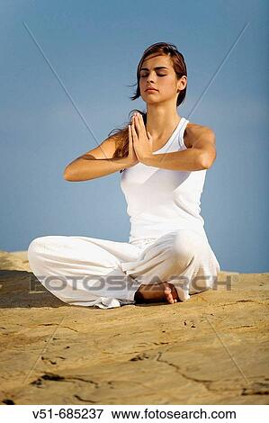 Young woman doing yoga in a cliff View Large Photo Image Stock Photo - Young woman doing yoga in a cliff. Fotosearch