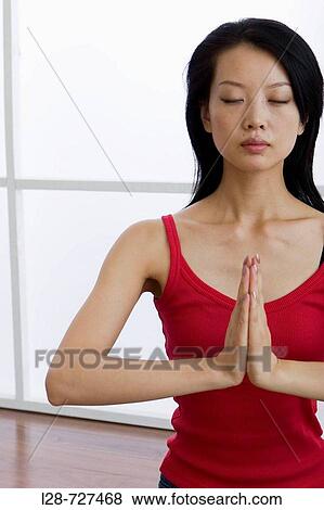 Young woman doing yoga in prayer position View Large Photo Image Stock Photo - Young woman doing yoga in prayer position. Fotosearch