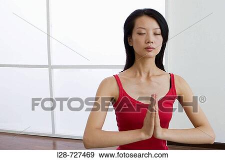 Young woman doing yoga in prayer position View Large Photo Image Stock Photo - Young woman doing yoga in prayer position. Fotosearch