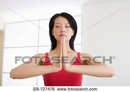 young woman doing yoga in prayer position View Large Photo Image Stock Photo - young woman doing yoga in prayer position. Fotosearch