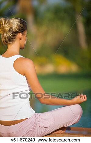 Young woman doing yoga on a pool deck View Large Photo Image Stock Photo - Young woman doing yoga on a pool deck. Fotosearch