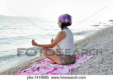 Young woman doing yoga on beach View Large Photo Image Stock Photography - Young woman doing yoga on beach. Fotosearch