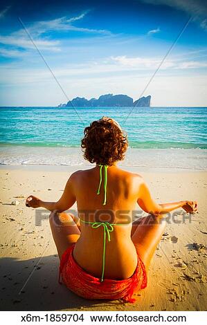 Young woman doing yoga on the beach Long beach Phi Phi Don island Krabi province, Andaman Sea, Thailand View Large Photo Image Picture - Young woman doing yoga on the beach Long beach Phi Phi Don island Krabi province, Andaman Sea, Thailand. Fotosearch