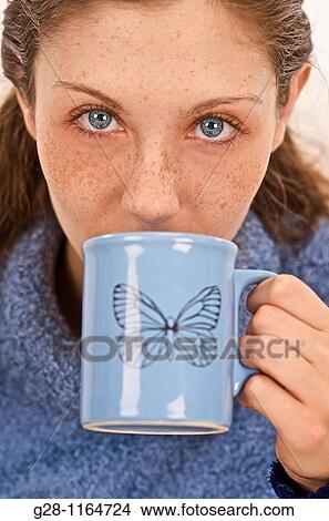 Young woman drinking a cup of tea ( close up ) View Large Photo Image Picture - Young woman drinking a cup of tea ( close up ). Fotosearch