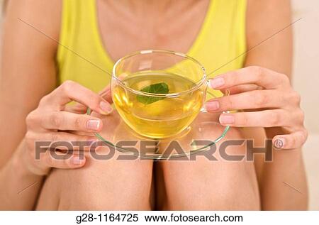 Young woman drinking a cup of tea ( close up ) View Large Photo Image Stock Photography - Young woman drinking a cup of tea ( close up ). Fotosearch