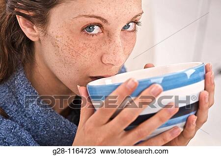 Young woman drinking a Liquid from a bowl( close up ) View Large Photo Image Stock Image - Young woman drinking a Liquid from a bowl( close up ). Fotosearch