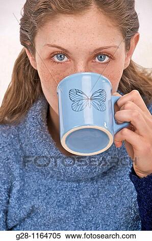 young woman drinking from a mug View Large Photo Image Stock Photography - young woman drinking from a mug. Fotosearch