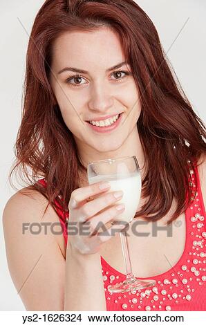 Young woman drinking milk from a wine glass View Large Photo Image Picture - Young woman drinking milk from a wine glass. Fotosearch