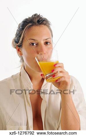 Young woman drinking orange juice View Large Photo Image Stock Image - Young woman drinking orange juice. Fotosearch