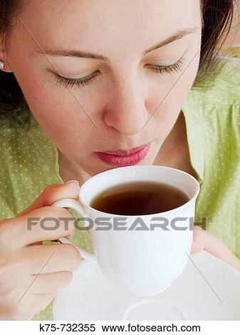 young woman drinking tea View Large Photo Image Stock Photography - young woman drinking tea. Fotosearch