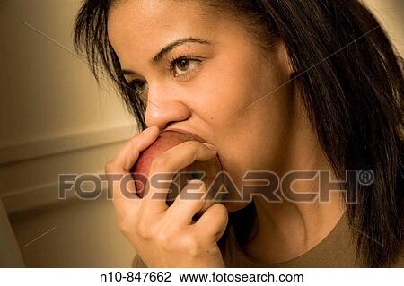 Young woman eating an apple. View Large Photo Image Stock Image - Young woman eating an apple.. Fotosearch