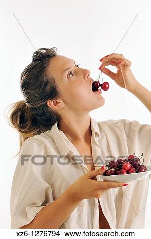 Young woman eating cherries View Large Photo Image Picture - Young woman eating cherries. Fotosearch
