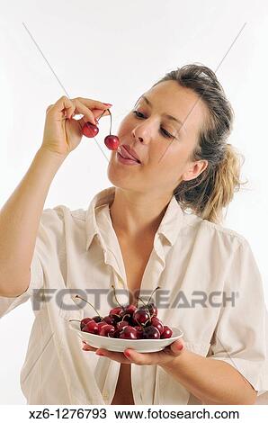 Young woman eating cherries View Large Photo Image Stock Image - Young woman eating cherries. Fotosearch