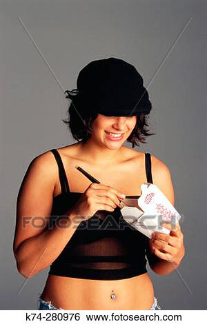 Young Woman Eating Chinese Food From A Takeout Container View Large Photo Image Stock Photograph - Young Woman Eating Chinese Food From A Takeout Container. Fotosearch