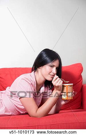 Young woman eating ice cream View Large Photo Image Stock Image - Young woman eating ice cream. Fotosearch