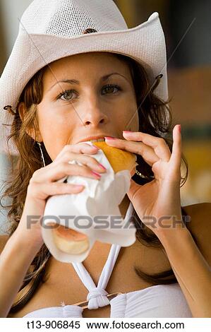 Young woman eating sandwich View Large Photo Image Stock Photography - Young woman eating sandwich. Fotosearch