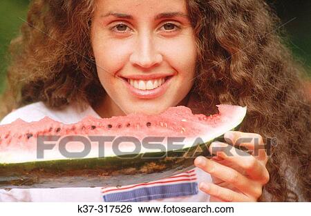 Young woman eating water melon View Large Photo Image Stock Photograph - Young woman eating water melon. Fotosearch