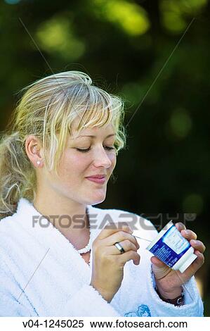 Young woman eating yoghurt View Large Photo Image Stock Photography - Young woman eating yoghurt. Fotosearch