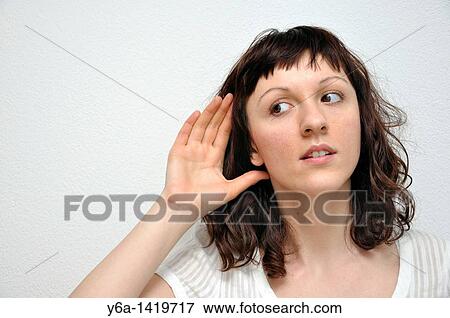 Stock Photo - Young woman eavesdropping. Fotosearch