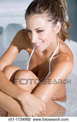 Young woman enjoying a bath View Large Photo Image Stock Image - Young woman enjoying a bath. Fotosearch
