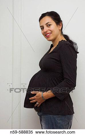 Young woman enjoying her pregnancy View Large Photo Image Stock Photography - Young woman enjoying her pregnancy. Fotosearch