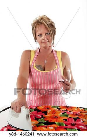 Stock Image - Young woman enjoying household work. Fotosearch