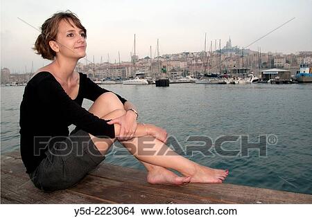young woman enjoying resting in old harbor of Marseille in the evening, Marseille, France. View Large Photo Image Picture - young woman enjoying resting in old harbor of Marseille in the evening, Marseille, France.. Fotosearch