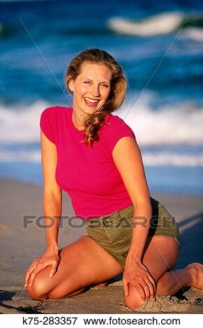 Young woman enjoying the beach View Large Photo Image Stock Photo - Young woman enjoying the beach. Fotosearch