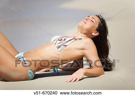 Young woman enjoying the sun in the beach View Large Photo Image Stock Image - Young woman enjoying the sun in the beach. Fotosearch