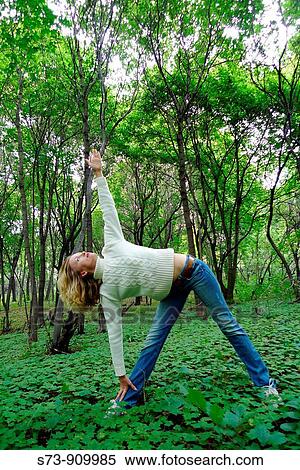 Young woman exercising and doing yoga in a russian forest, Molodeskiy Kurgan National Park, Samara Region, Russian Federation View Large Photo Image Stock Photography - Young woman exercising and doing yoga in a russian forest, Molodeskiy Kurgan National Park, Samara Region, Russian Federation. Fotosearch