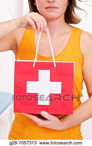 young woman ( face invisible ) holding a medical red bag with a white cross View Large Photo Image Stock Image - young woman ( face invisible ) holding a medical red bag with a white cross. Fotosearch