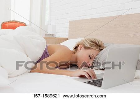Young woman fallen asleep while on her laptop View Large Photo Image Stock Image - Young woman fallen asleep while on her laptop. Fotosearch