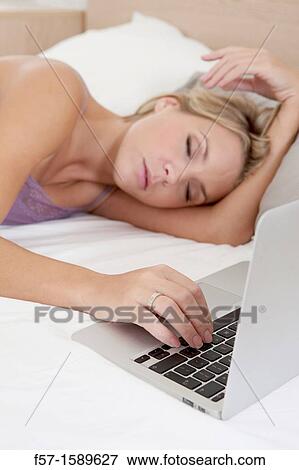 Young woman fallen asleep while on her laptop View Large Photo Image Stock Photo - Young woman fallen asleep while on her laptop. Fotosearch